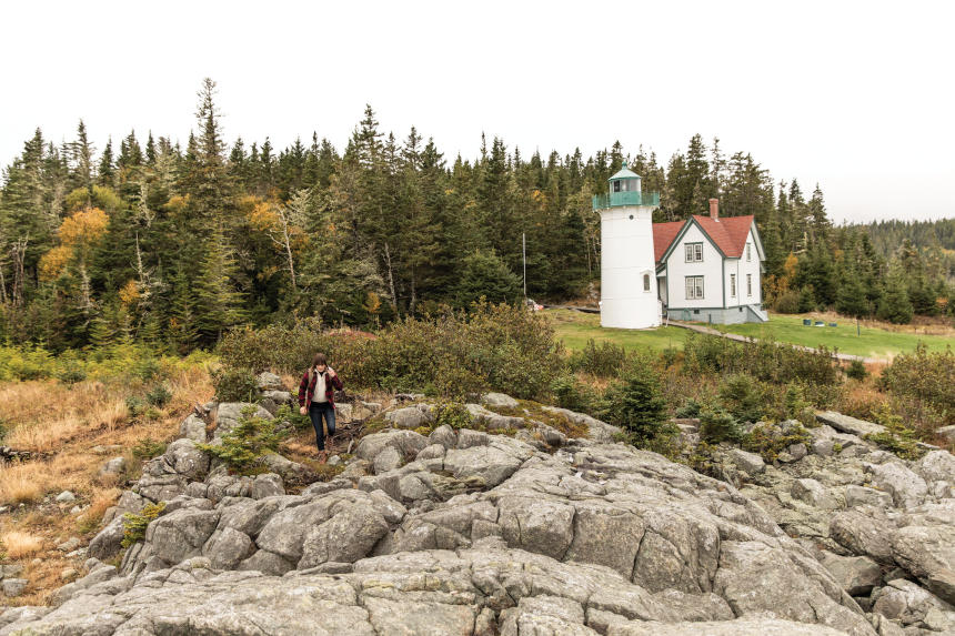 Woman walking on a coast in Maine