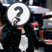 Singer with a question mark over their face.
