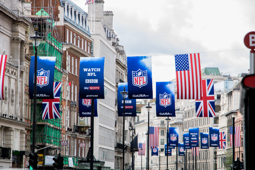 American and UK flags fly with banners advertising the NFL in central London