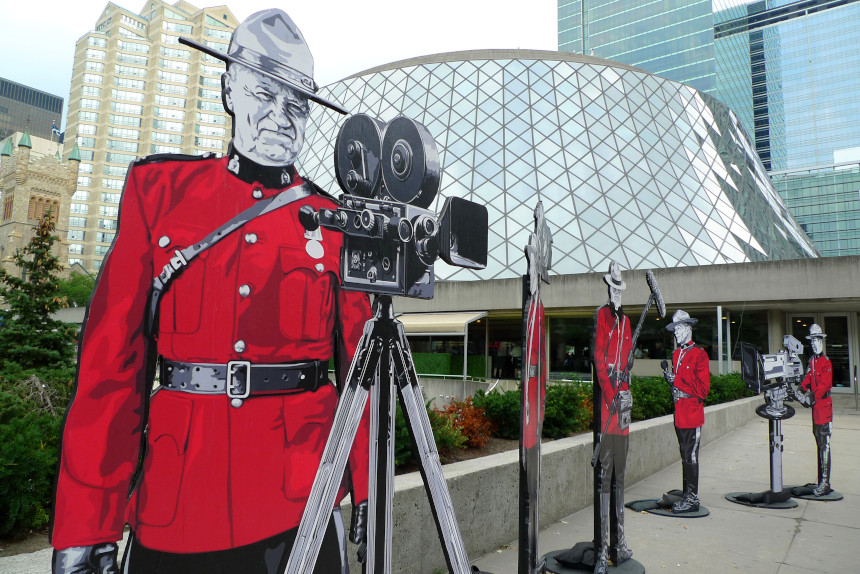 Cardboard cutouts shaped like Canadian Mounted Police with movie cameras are displayed outside the 2011 Toronto International Film Festival