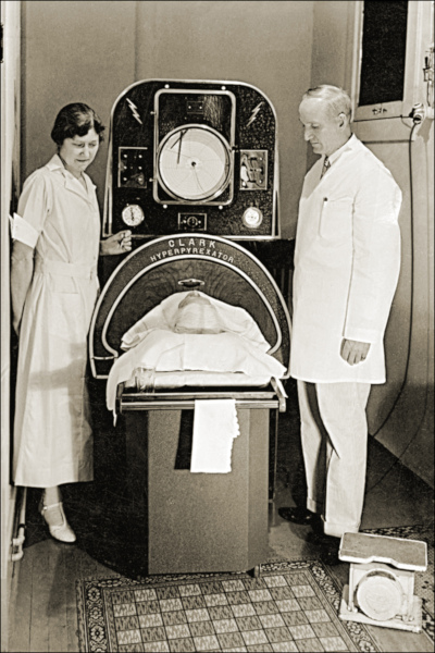 Photograph of a patient being inside an iron lung