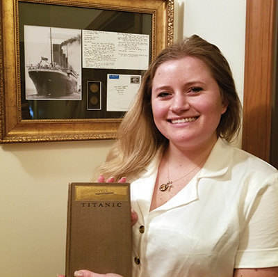 Christie Seyglinski holds a book about the Titanic