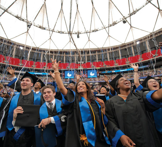 College graduates waving during commencement at Georgia State University