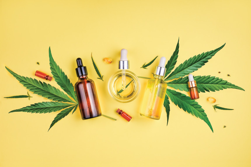 Bottles of CBD oil with hemp leaves