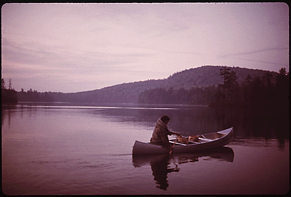 Man paddles in a canoe on Twitchell Lake