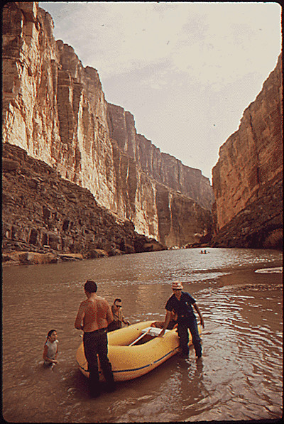 Family pulls their raft from the Rio Grande River