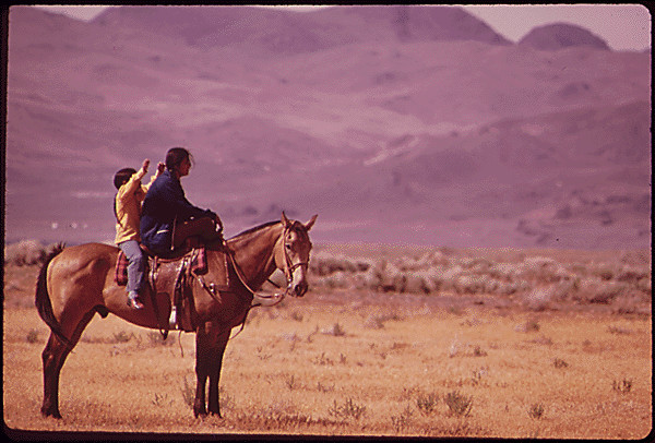 Woman and child on a horse in the Sutcliffe Indian Lake Reservation