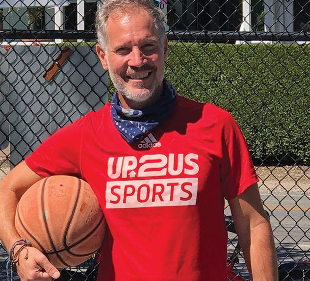 Photo of UP2US founder and CEO Paul Caccamo with a basketball