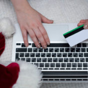 A holiday shopper buying a product online with their credit card.