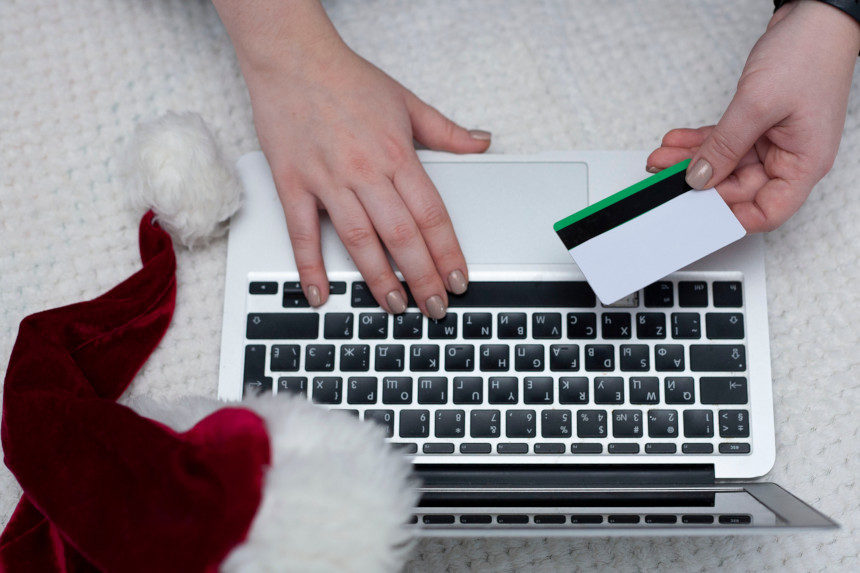 A holiday shopper buying a product online with their credit card.