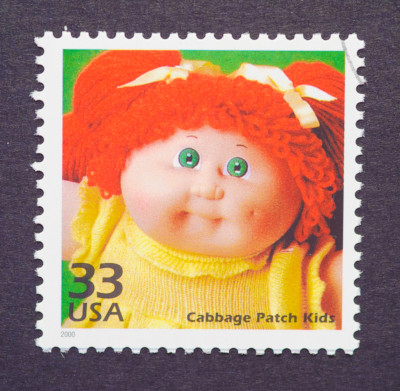 A postal stamp featuring a Cabbage Patch Kid