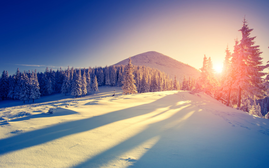 Sunrise over a snowy hill