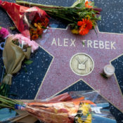 Flowers and candles are placed on Alex Trebek's star on the Hollywood Walk of Fame