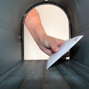 Man putting letter into mailbox