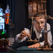 Older man measuring things using an antique scale