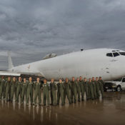 The crew for the E-6B Mercury aircraft pose with the plane at Minot Air Force Base