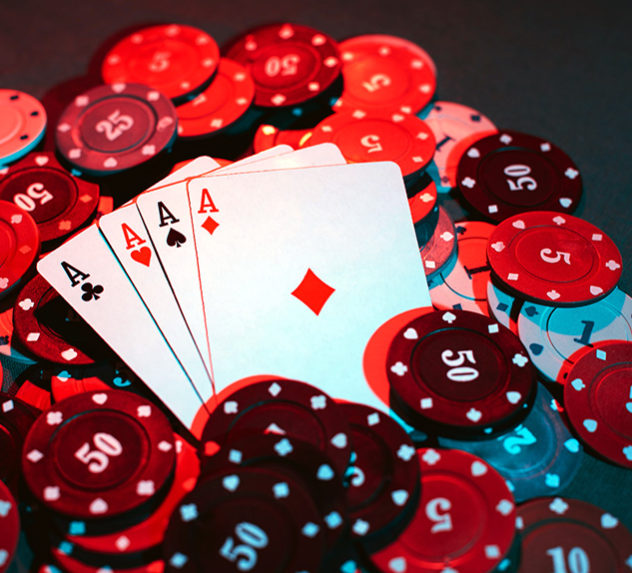 A poker hand rests on a pile of chips.