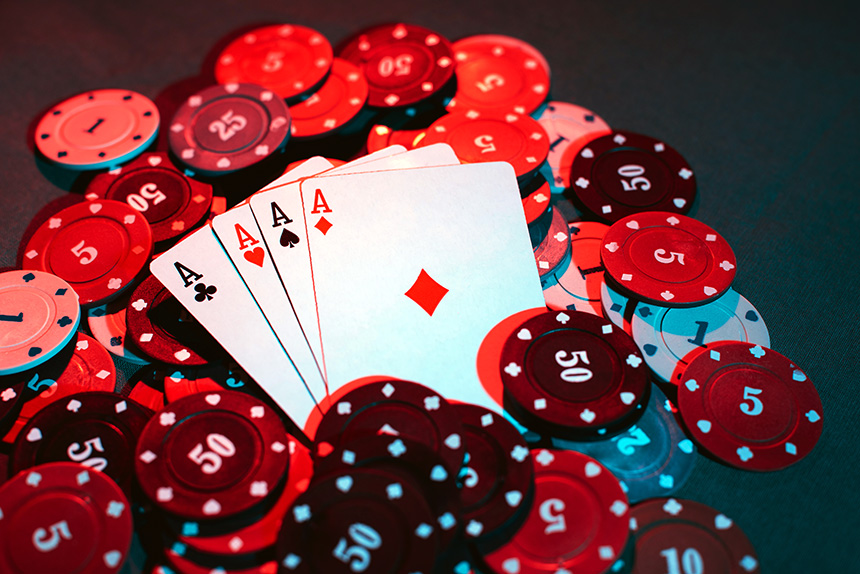 A poker hand rests on a pile of chips.