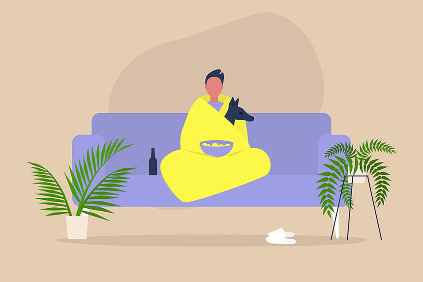Man bundled up with a blanket and his dog while watching TV at home.
