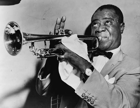 Jazz artist Louis Armstrong playing his trumpet