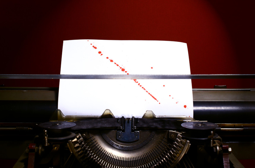 Typewriter with blood splattered on the inserted paper.