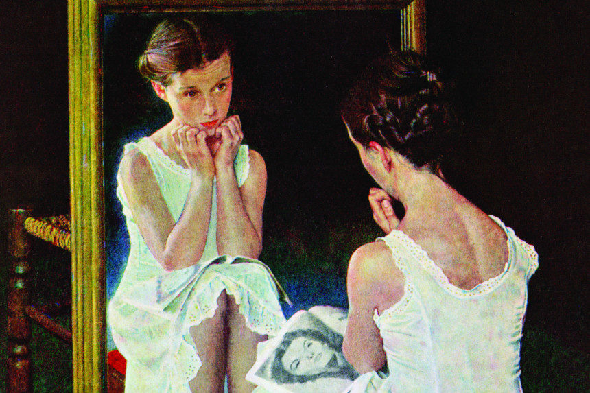 A young girl looks at herself in the mirror, comparing her looks to the Hollywood actress in her magazine.
