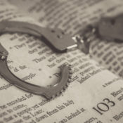 A pair of handcuffs on a Bible