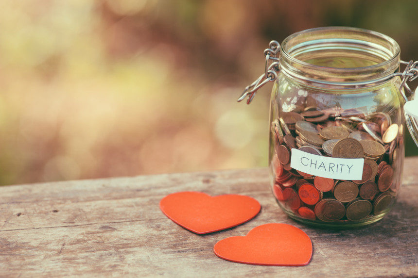 A jar full of pennies marked "charity"