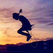 Silhouette of a girl jumping rope.