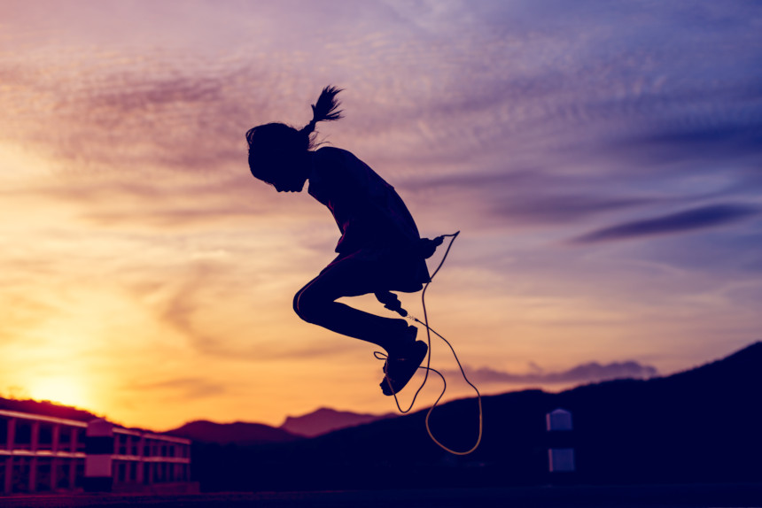 Silhouette of a girl jumping rope.