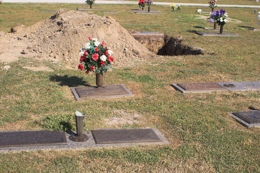 A cemetery with an open burial plot.