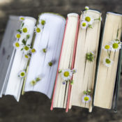 Books on a wooden table with flowers