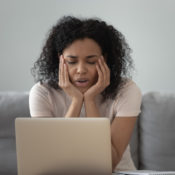 Bored woman fighting sleep during a long video conference.