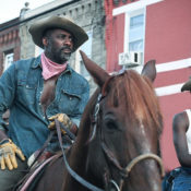 Scene from the film Concrete Cowboy featuring Idris Elba and Caleb McLaughlin