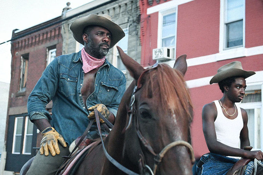 Scene from the film Concrete Cowboy featuring Idris Elba and Caleb McLaughlin