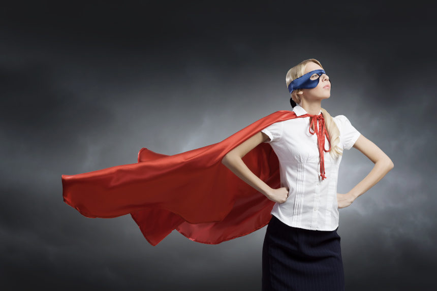 Woman wearing a super hero mask and cape.