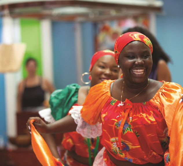 Female dancers in traditional Hattian dress perform in Miami's Little Haiti.