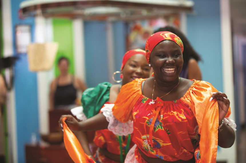 Female dancers in traditional Hattian dress perform in Miami's Little Haiti.