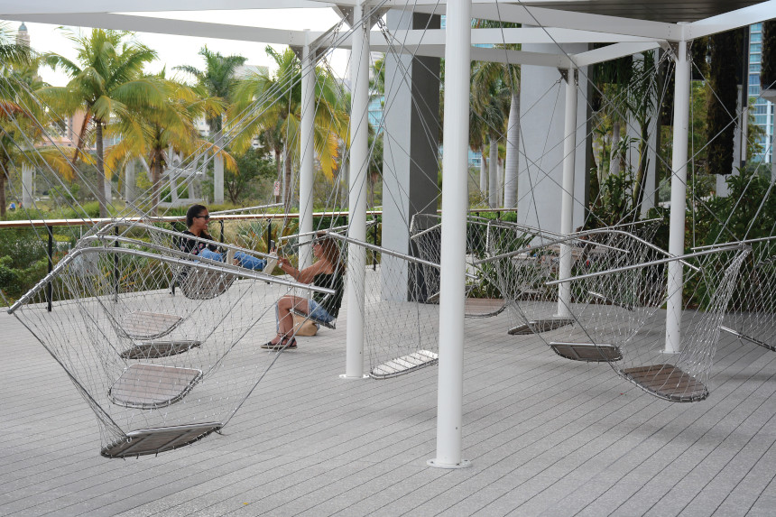 Visitors rest in swing chairs at the Pérez Art Museum in Miami
