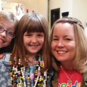 Jean Gribbon of Beads of Courage with two child cancer patients. One of them is wearing beads.