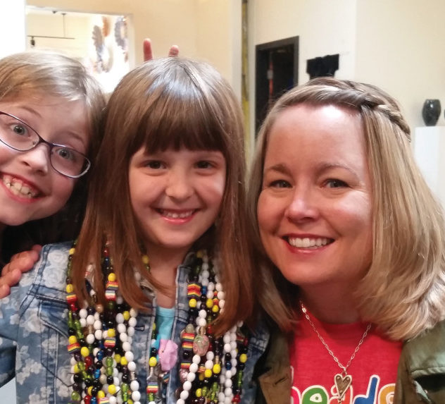 Jean Gribbon of Beads of Courage with two child cancer patients. One of them is wearing beads.