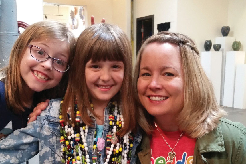 Jean Gribbon of Beads of Courage with two child cancer patients. One of them is wearing beads.