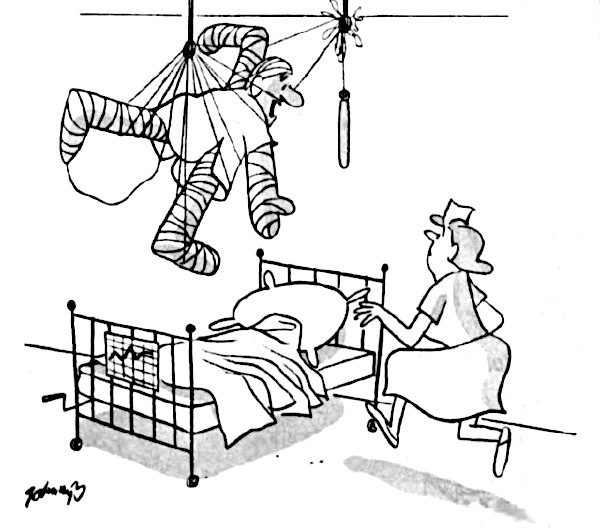 Man in bandages is tangled up in wires above his hospital bed.