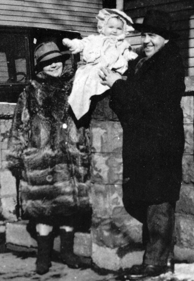 An infant Val Lauder with her mother and father.