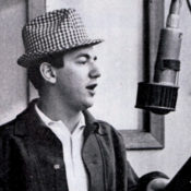 Bobby Darren singing into a studio mic