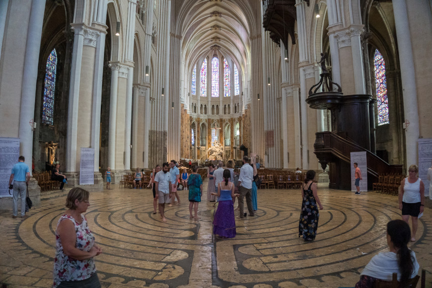 Visitors walk along a labyrinth floor pattern in the Cathedral of Chartres