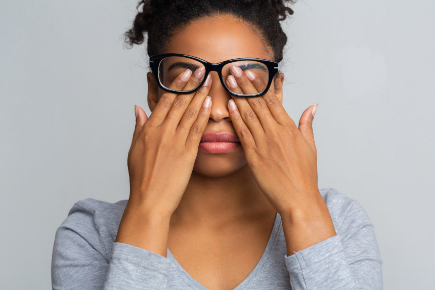 Woman rubbing her eyes.