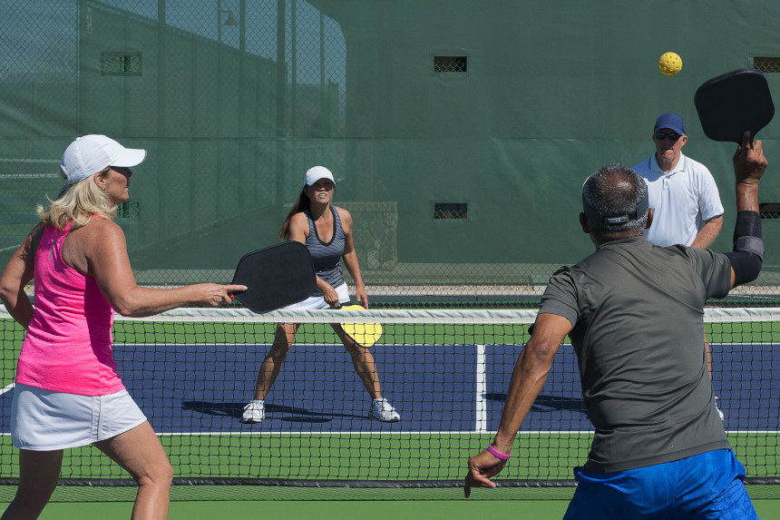 People playing pickleball, a variant of tennis