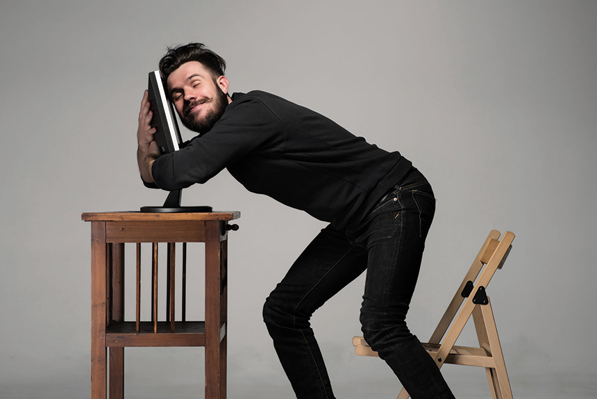 Man hugging his computer