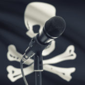 Microphone in front of a jolly roger flag
